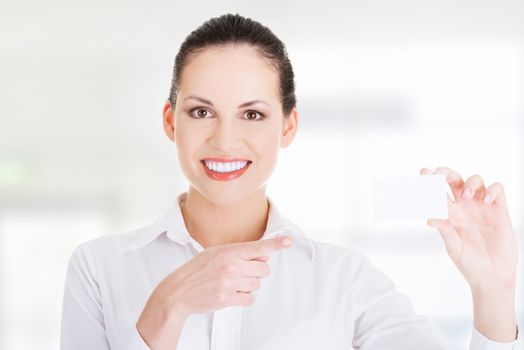 Beautiful smiling businesswoman with businesscard. Isolated on white