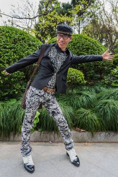 SHANGHAI - APRIL 7: one stylish fashionable chinese man posing smiling on april 7th, 2013 in Shanghai