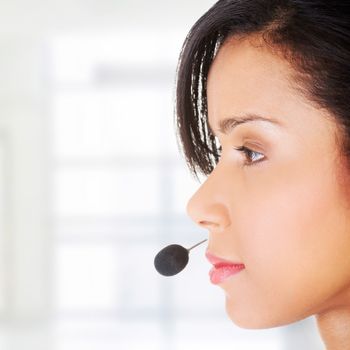 Beautiful young call-center assistant smiling , isolated