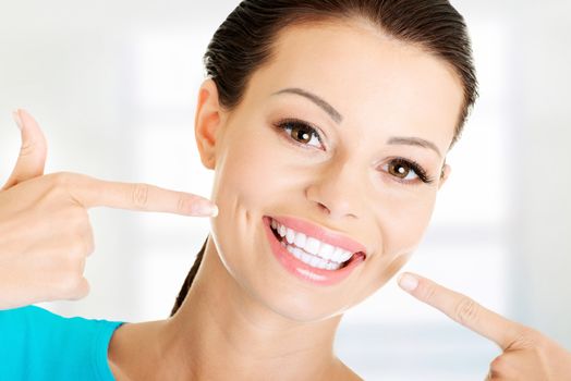 Woman showing her perfect straight white teeth.