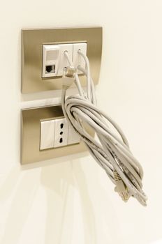 European electrical socket and ethernet socket on the wall, with ethernet cable