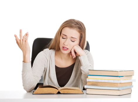 Beautiful resigned student woman with stack of books. Isolated on white.