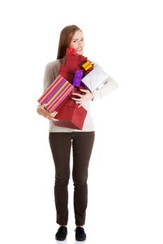 Beautiful casual woman holding presents in boxes. Isolated on white.