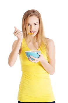 Beautiful caucasian woman eating cereals. Isolated on white.