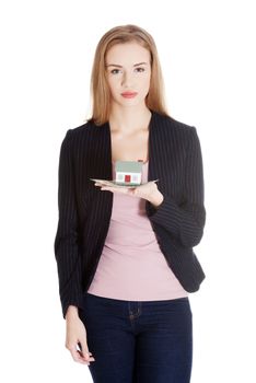 Beautiful business woman holding dollar currency and house. Isolated on white.