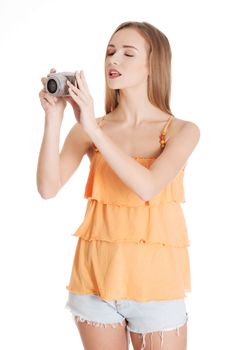 Young summer woman is taking a photo. Isolated on white.