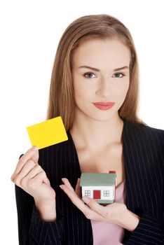 Beautiful business woman holding small house and personal card. Isolated on white.