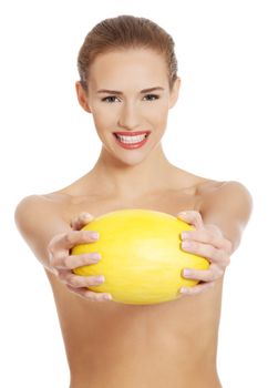 Beautiful naked caucasian woman holds yellow fresh melon. Isolated on white.