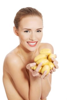 Beautiful naked woman holding raw potatoes in hands. Isolated on white.