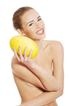 Beautiful naked caucasian woman holds yellow fresh melon. Isolated on white.