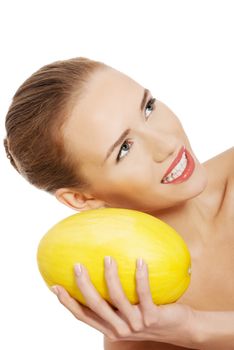 Beautiful naked caucasian woman holds yellow fresh melon. Isolated on white.