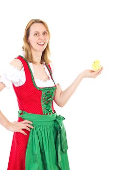 Girl wearing red dirndl and holding tiny chick in her hand