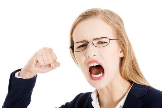 Furious angry business woman trying to punch you. Isolated on white.