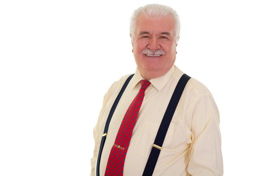 Happy senior man with a moustache wearing braces and a red tie looking at the camera with a charming beaming smile isolated on white