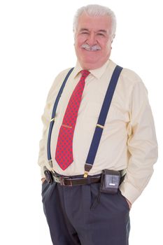 Confident portly senior gentleman with a moustache wearing braces and a tie standing in a relaxed pose with his hands in his pocket smiling at the camera