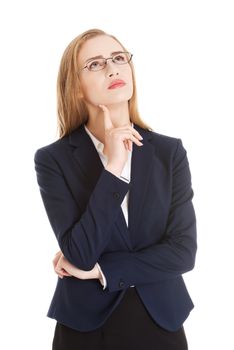 Beautiful business woman in eyeglasses with finger on her cheek is thinking, having an idea. Isolated on white.