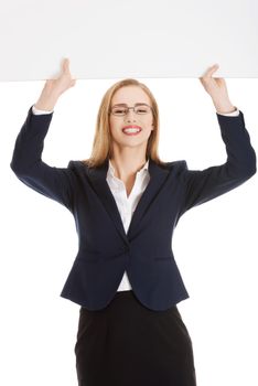 Beautiful young business woman holding copy space. Isolated on white.