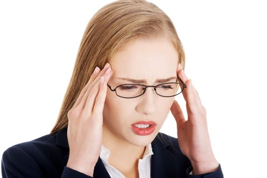 Beautiful business woman is having a headache. Isolated on white.