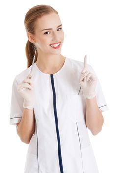 Young beautiful dentist woman with equipment. Isolated on white.