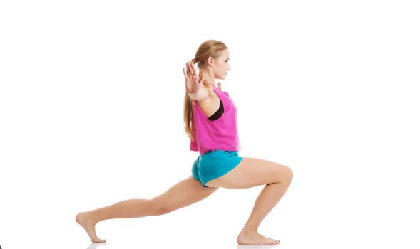 Young caucasian woman is exercising, stretching herself. Isolated on white.