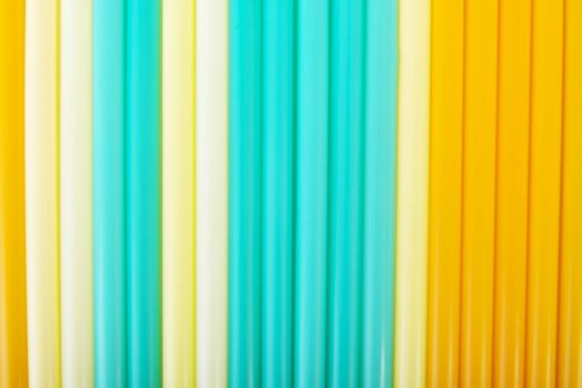 Composition of colorful straws. Blue, yellow or white.