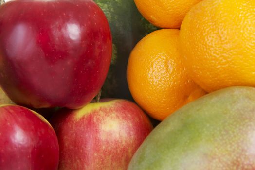 Close up on fresh fruits: mango, oranges,grapes, coconut,apples.