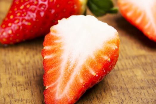 Close up on a fresh red strawberry with sugar.