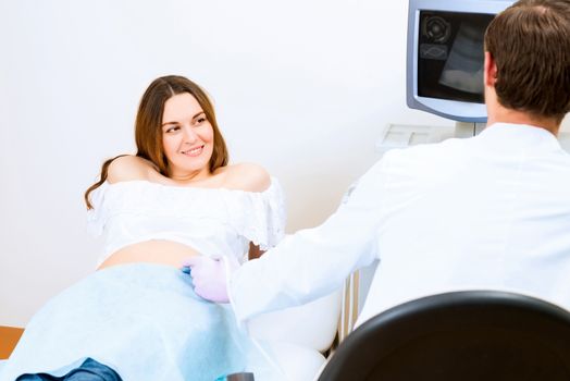 Young attractive pregnant woman on reception at the doctor, health check