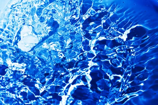 Blue transparent water splashes on white background