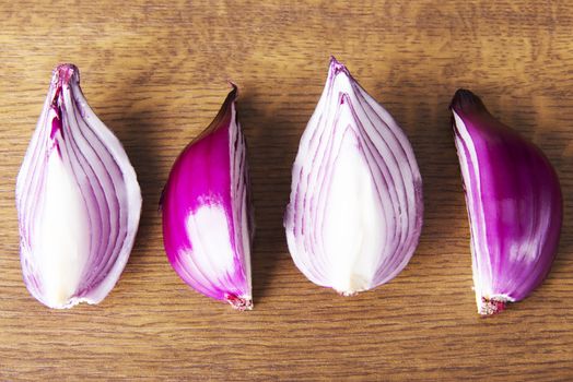 Composition of red onions. Over wooden background.