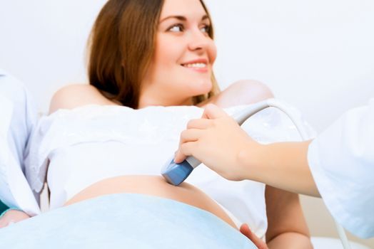 hands and abdominal ultrasound scanner for pregnant women