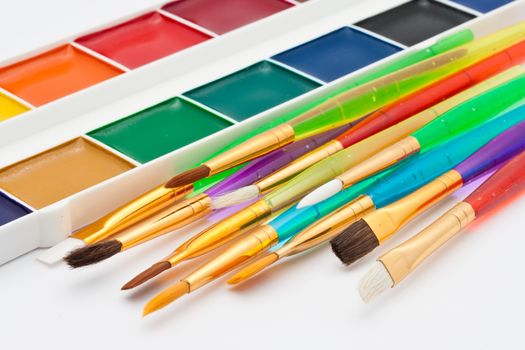 Set of artistic brushes and paints on white background
