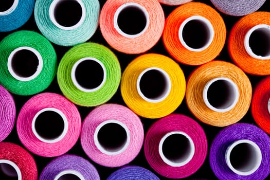 Sewing threads as a multicolored background close up