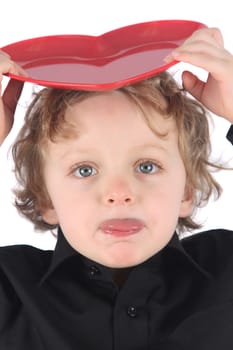 Blond boy with a red heart on his head