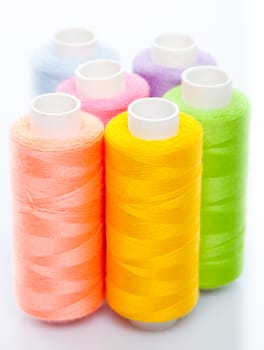 Sewing multicolored threads isolated on a white