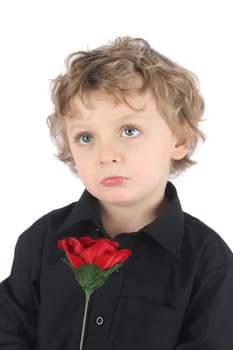 Pouting blonde boy holding a red rose