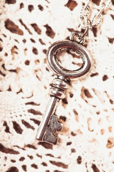 Vintage key on the white aged lace