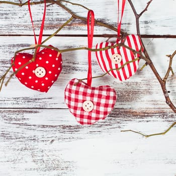 Valentine decorations: textile red hearts on the 
branch