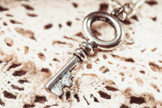 Vintage key on the white aged lace