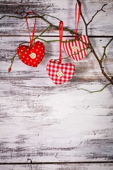 Valentine decorations: textile red hearts on the 
branch