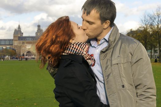 Outdoor happy couple in love, Museum Plein, autumn Amsterdam background