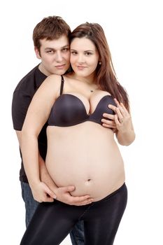 loving happy couple, pregnant woman with her husband, isolated on white background