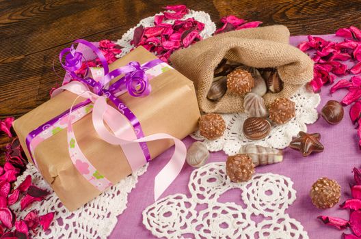 Valentines gift in a still life with flower petals and treats