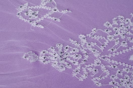 Elegant embroidery  on a  purple colored fabric