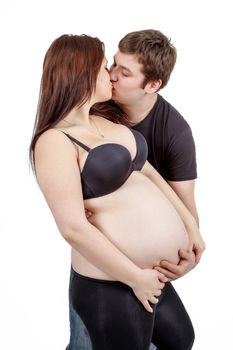 loving happy couple, pregnant woman with her husband, husband kissing woman isolated on white background