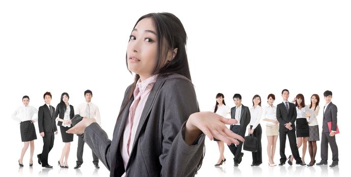 Attractive Asian business woman give you a helpless sign and stand in front of her team.