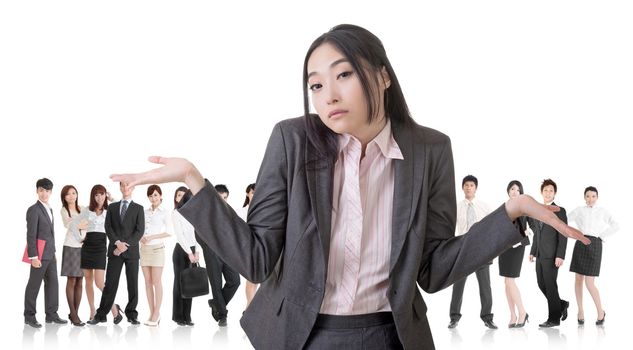 Attractive Asian business woman give you a helpless sign and stand in front of her team.