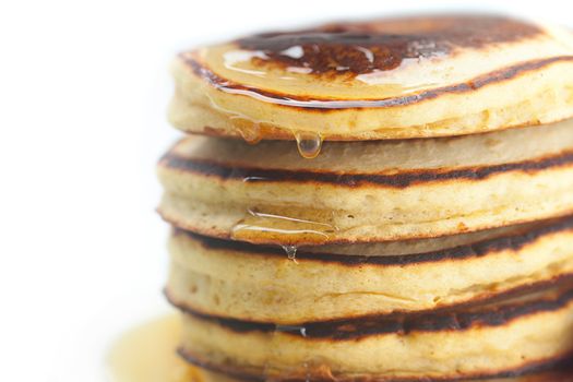 Pancakes and honey isolated on white