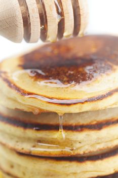 Pancakes, honey and stick to honey isolated on white