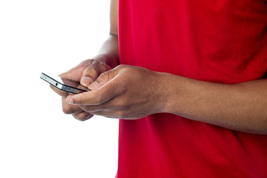 Cropped image of man sending text messages via cell phone
